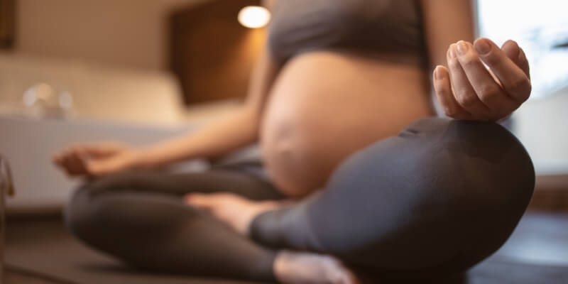Pregnant woman practising prenatal yoga 
