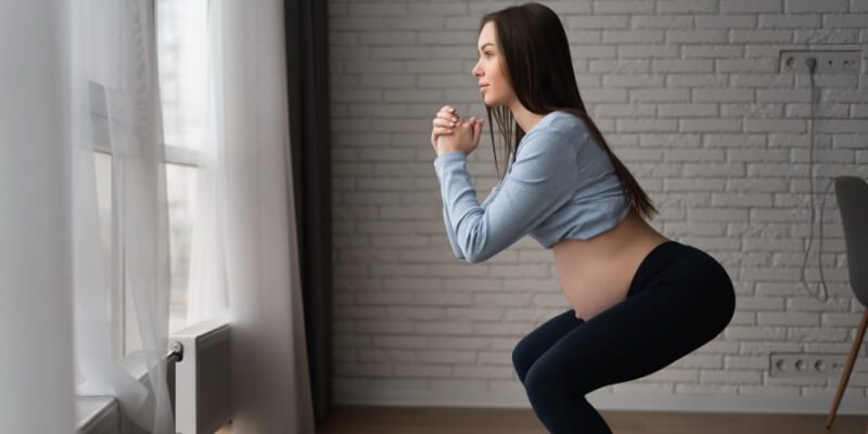 Woman performing a squat exercise at home 